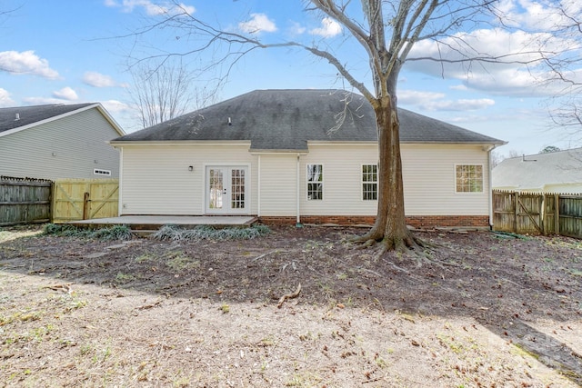 back of property with a patio area, fence, and french doors