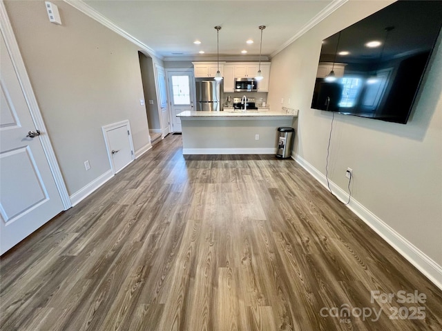 kitchen with stainless steel appliances, dark wood-type flooring, baseboards, light countertops, and ornamental molding