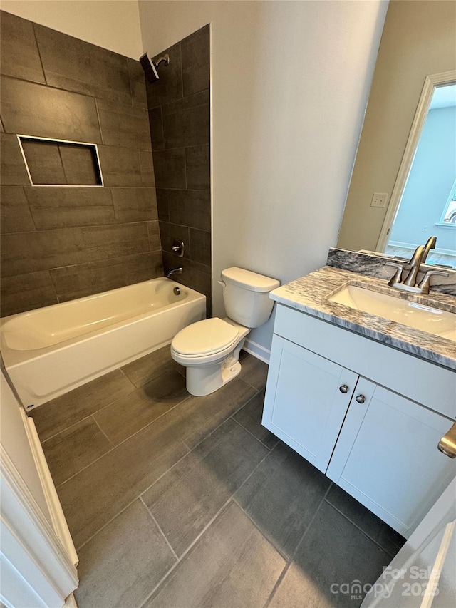 bathroom with washtub / shower combination, baseboards, vanity, and toilet