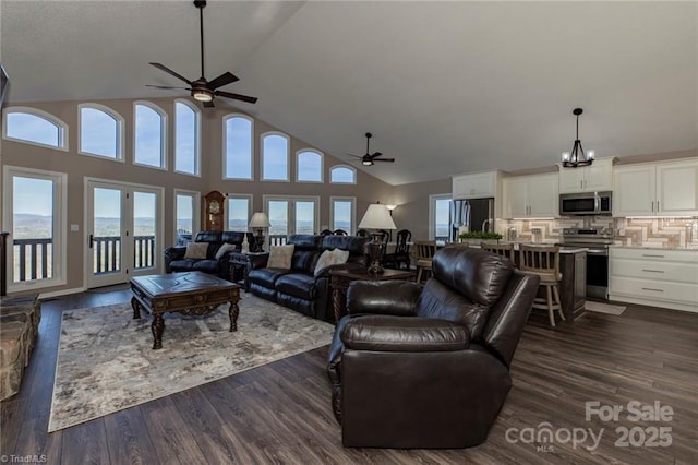 living room with a healthy amount of sunlight, ceiling fan, dark wood-style flooring, and french doors