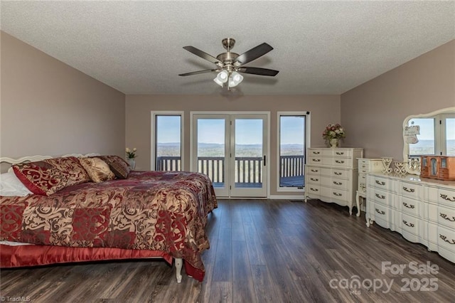 bedroom featuring access to exterior, a textured ceiling, a ceiling fan, and dark wood-type flooring