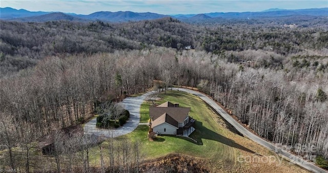 bird's eye view with a forest view and a mountain view