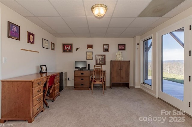 home office featuring light carpet, baseboards, and a paneled ceiling