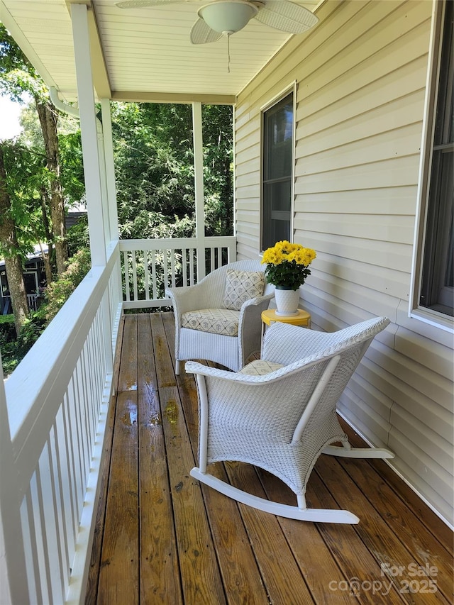 wooden terrace with ceiling fan and a porch