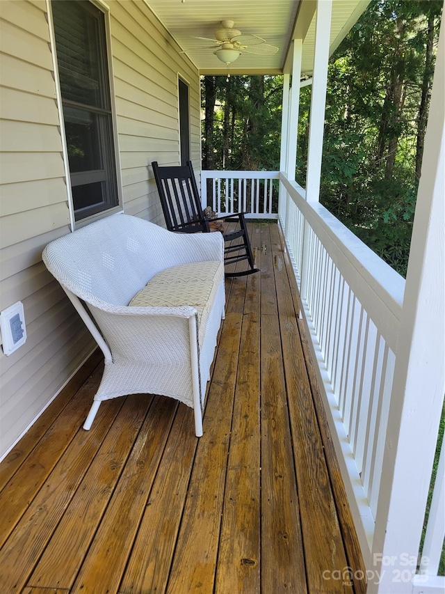 wooden terrace featuring a porch and a ceiling fan