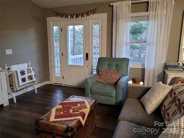 living room with baseboards and dark wood finished floors