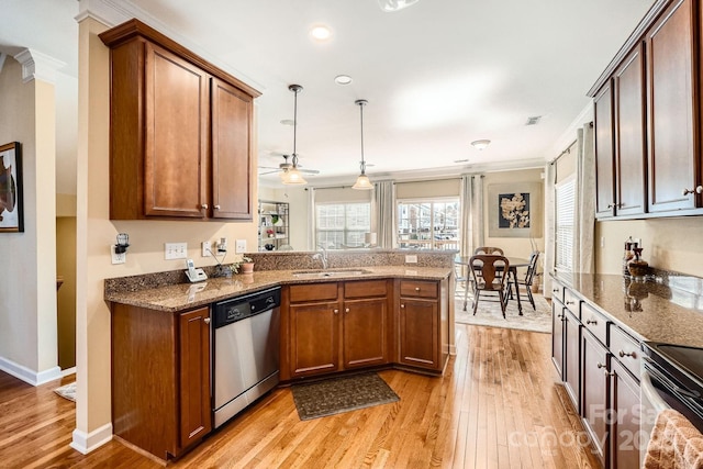 kitchen with dishwasher, a peninsula, light wood-type flooring, and a sink