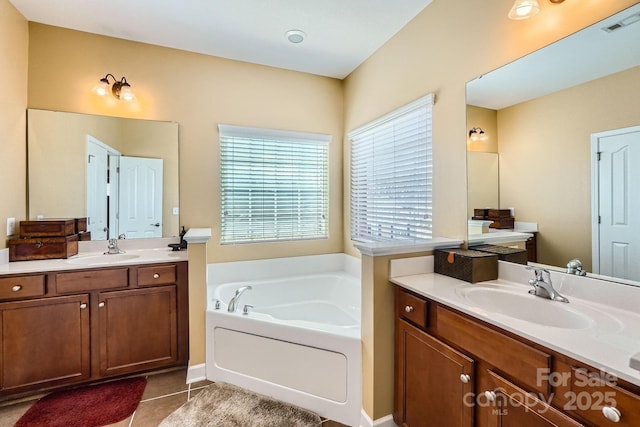 bathroom with two vanities, a garden tub, a sink, and tile patterned floors