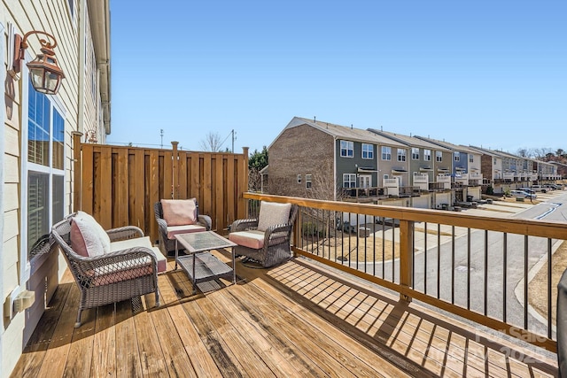 wooden terrace featuring a residential view and an outdoor living space