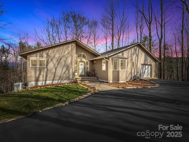 view of front of home featuring driveway and a garage