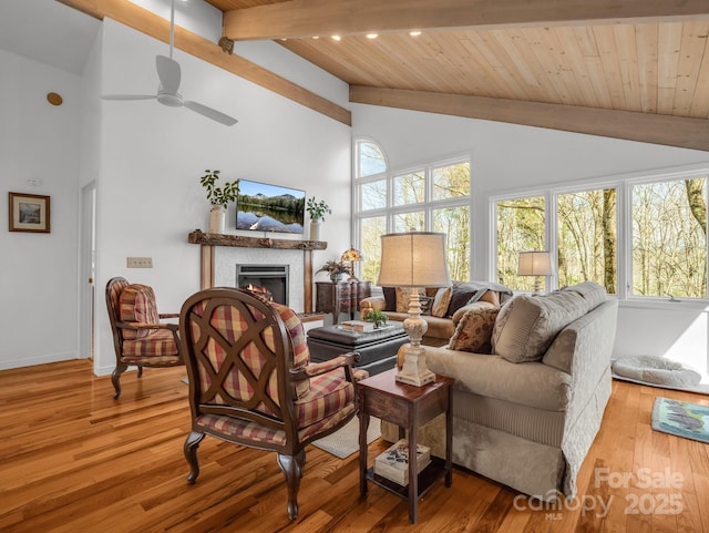 209 Walnut Ridge Rd, Brevard, NC 28712 - living area with beamed ceiling, wood ceiling, wood finished floors, and a lit fireplace