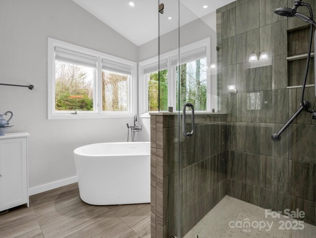 209 Walnut Ridge Rd, Brevard, NC 28712 - full bathroom with a soaking tub, baseboards, a stall shower, and lofted ceiling