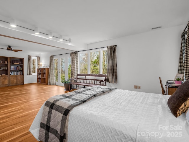 209 Walnut Ridge Rd, Brevard, NC 28712 - bedroom featuring rail lighting, visible vents, and wood finished floors