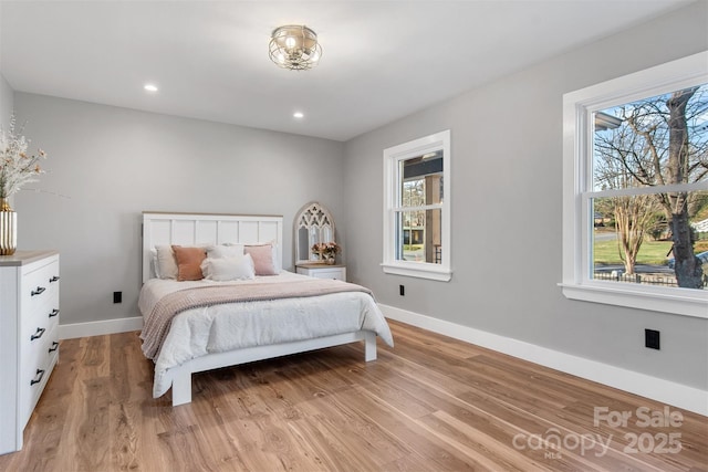 bedroom with recessed lighting, baseboards, and light wood-type flooring