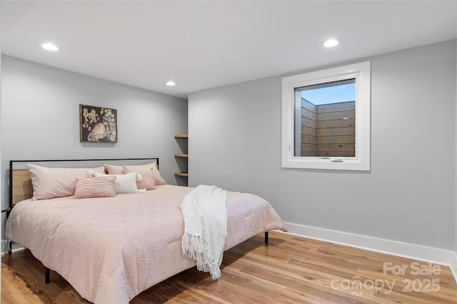 bedroom featuring recessed lighting, wood finished floors, and baseboards