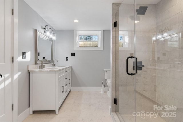 full bathroom featuring marble finish floor, a stall shower, and double vanity