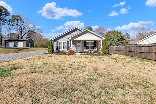 bungalow-style house with a porch, a front lawn, a garage, and fence