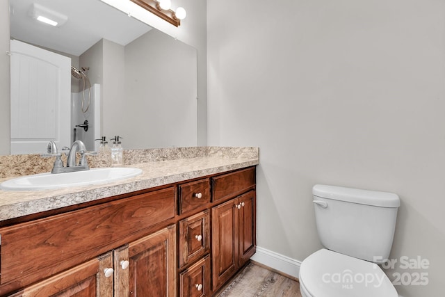 full bath with vanity, toilet, and baseboards