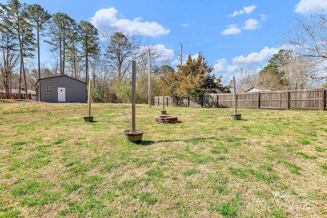 view of yard featuring a fire pit and fence