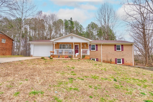 single story home featuring a garage, brick siding, covered porch, and driveway