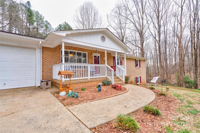 ranch-style house featuring brick siding, covered porch, concrete driveway, and an attached garage