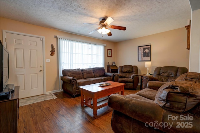 living area featuring baseboards, a textured ceiling, wood finished floors, and a ceiling fan