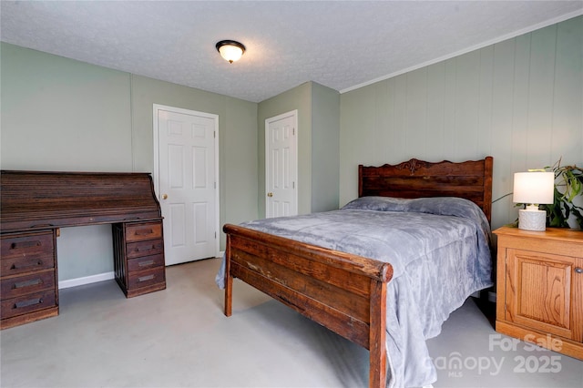 bedroom with finished concrete floors and a textured ceiling