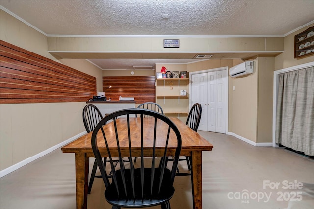 dining space featuring visible vents, a textured ceiling, a wall unit AC, and finished concrete floors