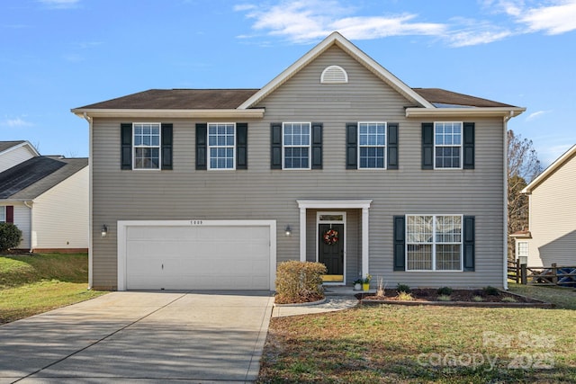 colonial home featuring a garage, driveway, and a front lawn