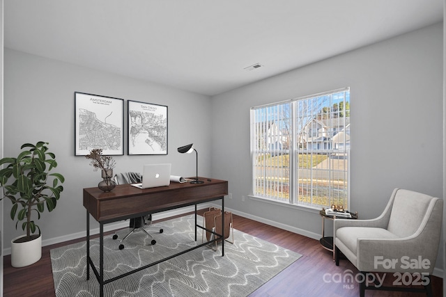 office area with visible vents, baseboards, and wood finished floors