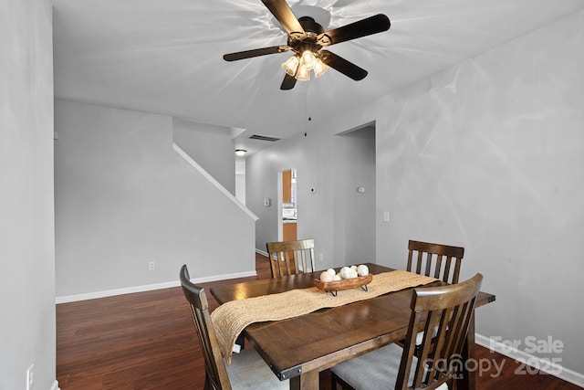 dining area featuring a ceiling fan, wood finished floors, visible vents, and baseboards