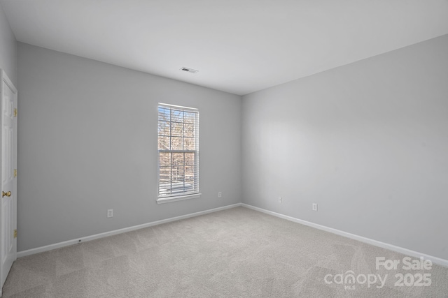 empty room featuring baseboards and carpet flooring