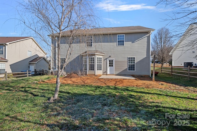 rear view of property featuring a patio area, a fenced backyard, and a yard