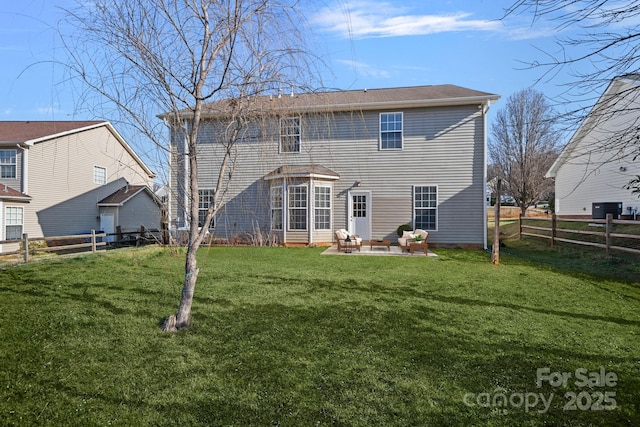 back of property with a patio area, a fenced backyard, and a yard