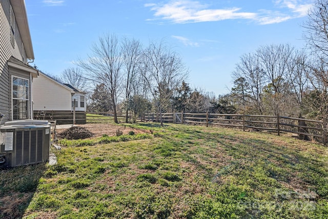 view of yard with fence and central AC unit