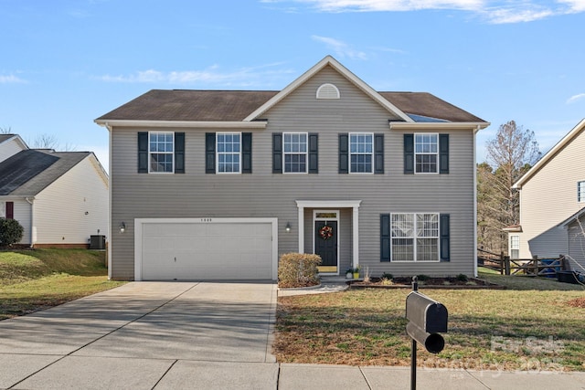 colonial-style house featuring concrete driveway, an attached garage, central AC unit, fence, and a front lawn