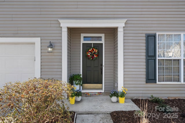 entrance to property with an attached garage