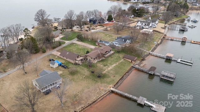 drone / aerial view featuring a residential view and a water view