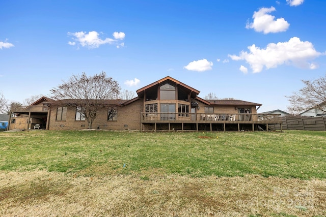 rear view of property featuring crawl space, a yard, a deck, and fence