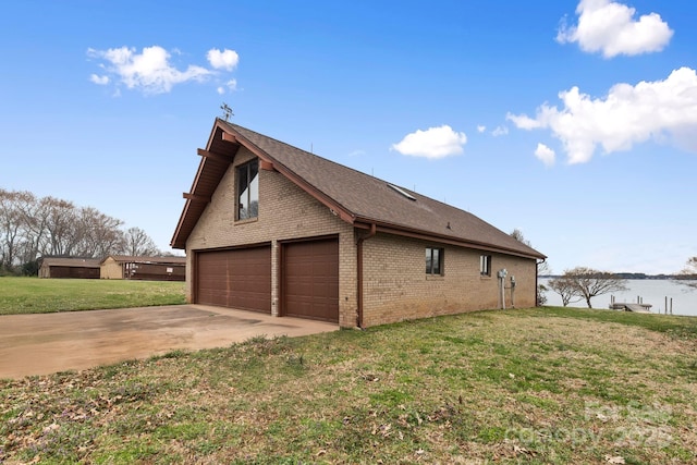 view of side of property with brick siding and a lawn