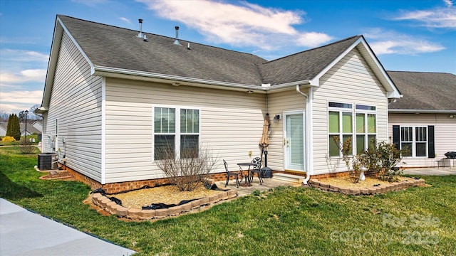 back of house featuring a patio, a yard, central AC unit, and roof with shingles