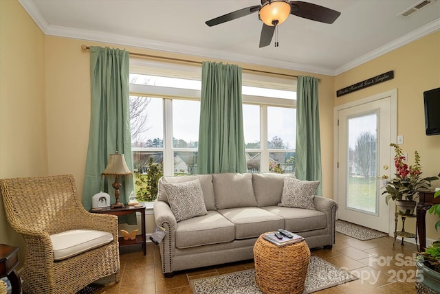 living area featuring visible vents, plenty of natural light, and crown molding