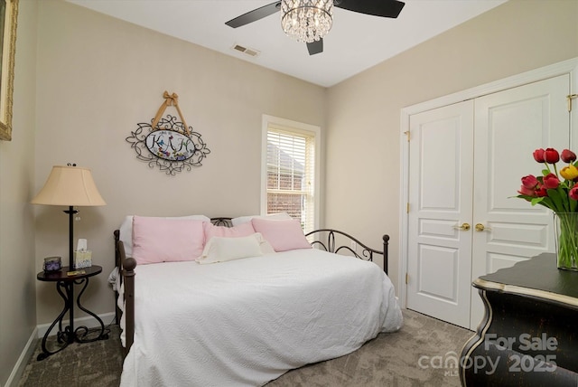 carpeted bedroom with visible vents, baseboards, a closet, and a ceiling fan