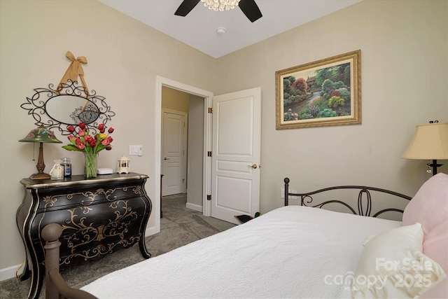 carpeted bedroom featuring baseboards and ceiling fan