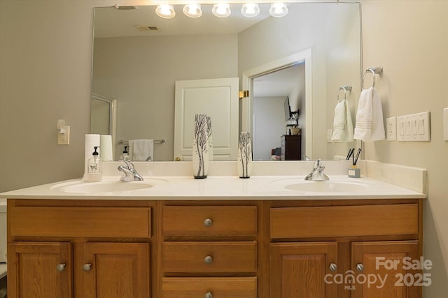 full bathroom with a sink, visible vents, and double vanity