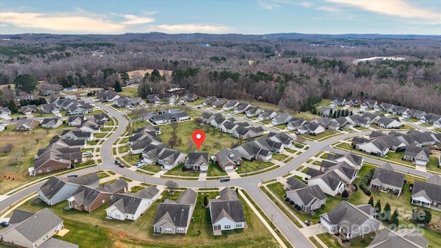 aerial view with a wooded view and a residential view