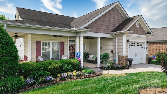 313 Garner Dr, Salisbury, NC 28146 - craftsman-style home with a garage, covered porch, stone siding, a ceiling fan, and driveway