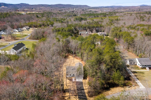 aerial view featuring a forest view and a mountain view