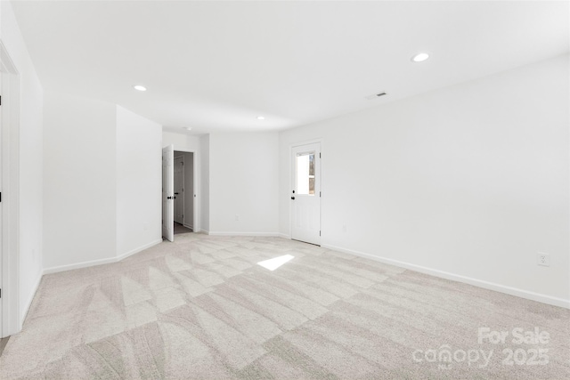 empty room with light carpet, visible vents, baseboards, and recessed lighting