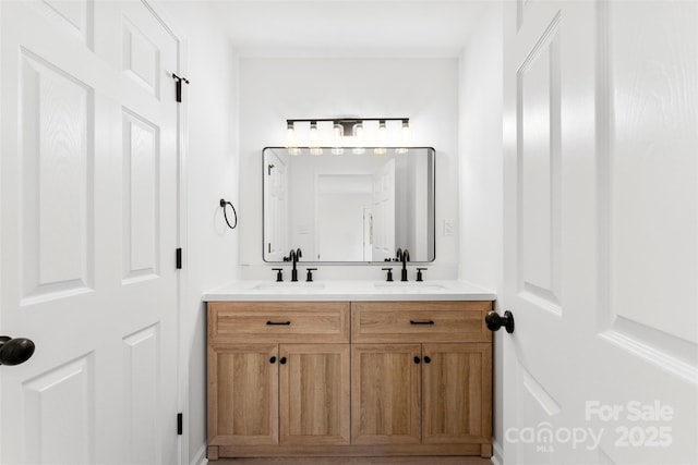 bathroom with a sink and double vanity